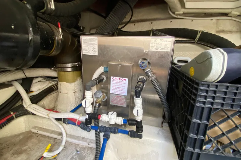 Slide: The Image of Engine room of 2004 Carver 36 Super Sport with plumbing and equipment. - 55