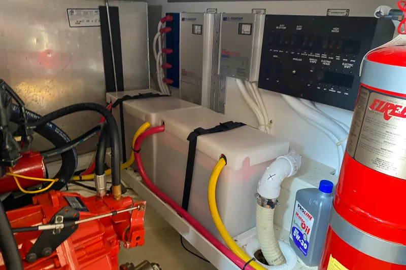 Slide: The Image of Engine room of a 2004 Carver 36 Super Sport with fire extinguisher and oil container. - 58