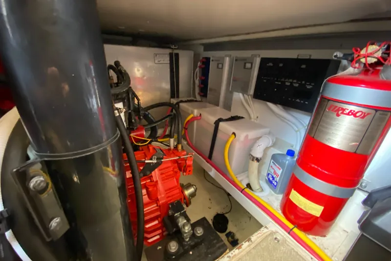 Slide: The Image of Engine room of 2004 Carver 36 Super Sport with fire extinguisher and control panels. - 61