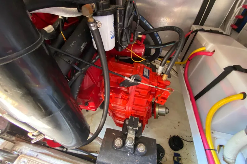 Slide: The Image of Engine compartment of a 2004 Carver 36 Super Sport boat, featuring red engine components. - 64