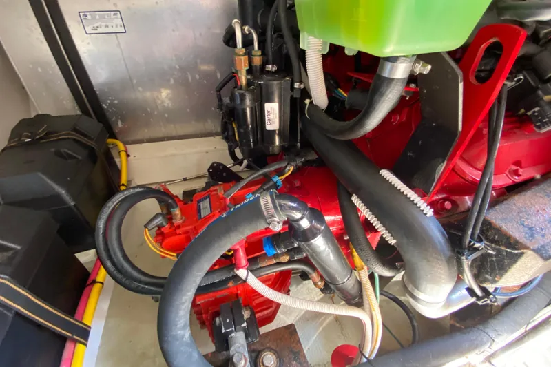 Slide: The Image of Engine compartment of a 2004 Carver 36 Super Sport boat, showcasing hoses and components. - 65