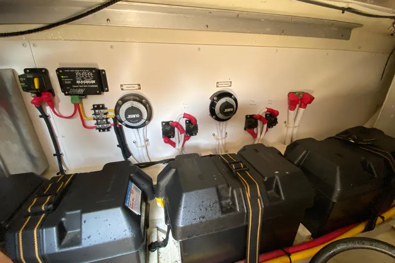 Slide: The Image of Electrical system of a 2004 Carver 36 Super Sport boat, featuring battery chargers and connections. - 66