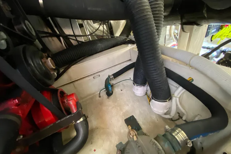 Slide: The Image of Engine compartment of a 2004 Carver 36 Super Sport with hoses and mechanical components. - 67