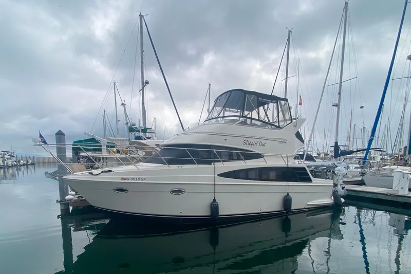 Slide: The Image of 2004 Carver 36 Super Sport yacht docked in a marina under cloudy skies. - 72