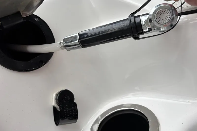 Slide: The Image of Fueling port and hose on a 2022 Yamaha Boats 252S. - 15