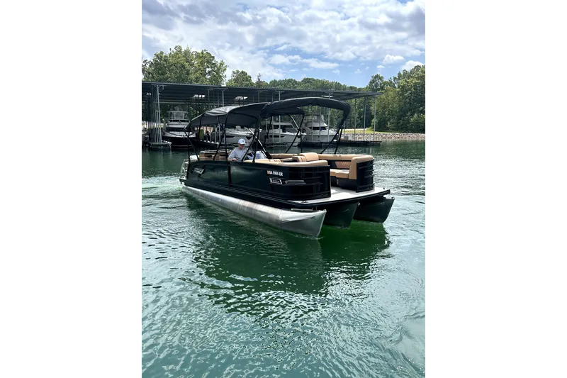 Slide: The Image of 2025 Godfrey AquaPatio Entertainment 255 CBE pontoon boat on a serene lake. - 7