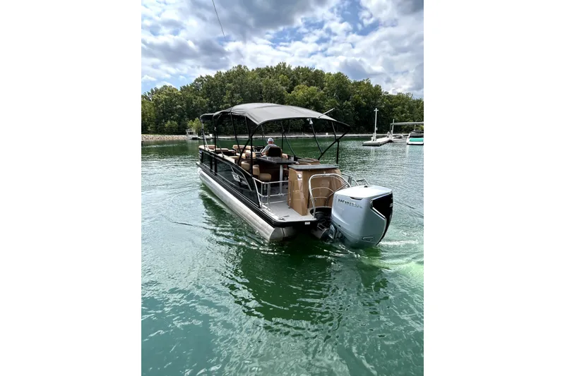 Slide: The Image of 2025 Godfrey AquaPatio Entertainment 255 CBE pontoon boat on a serene lake. - 8