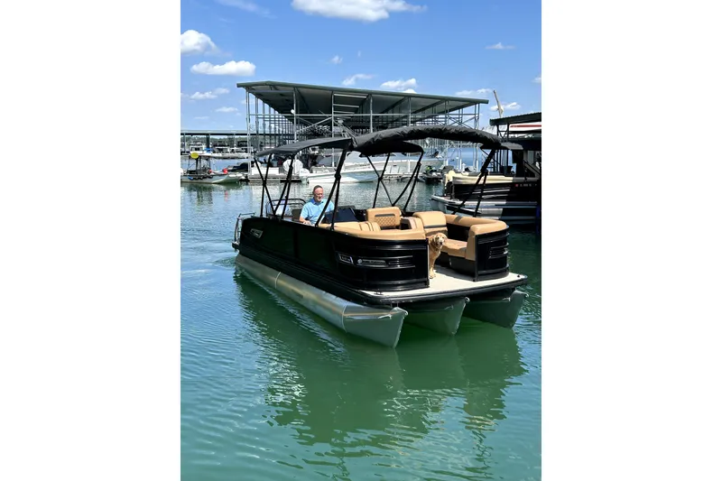 Slide: The Image of 2025 Godfrey AquaPatio Entertainment 255 CBE pontoon boat on a sunny lake. - 9