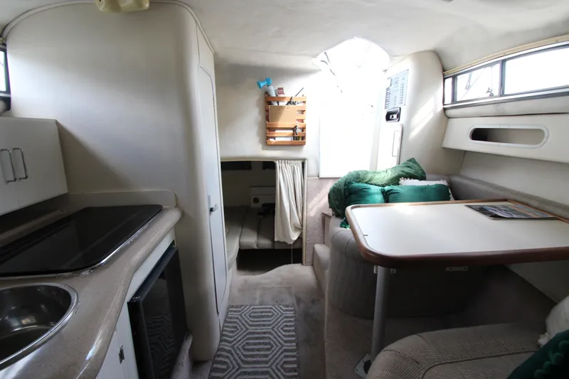 Slide: The Image of Interior of 1996 Monterey 296 Cruiser boat with kitchenette and seating area. - 14