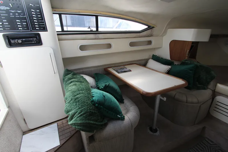 Slide: The Image of Interior of 1996 Monterey 296 Cruiser with cozy seating and table setup. - 18