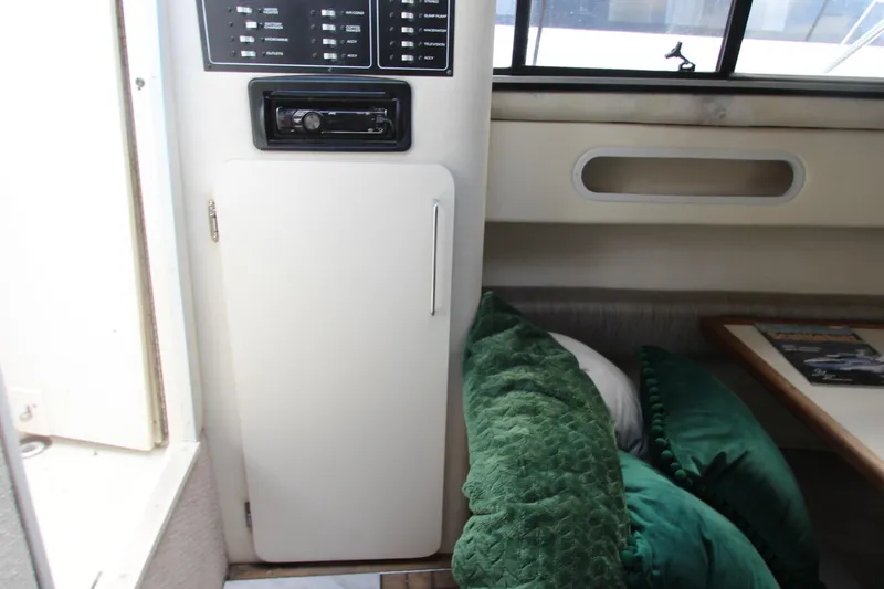 Slide: The Image of Interior of 1996 Monterey 296 Cruiser with control panel and green cushions. - 19