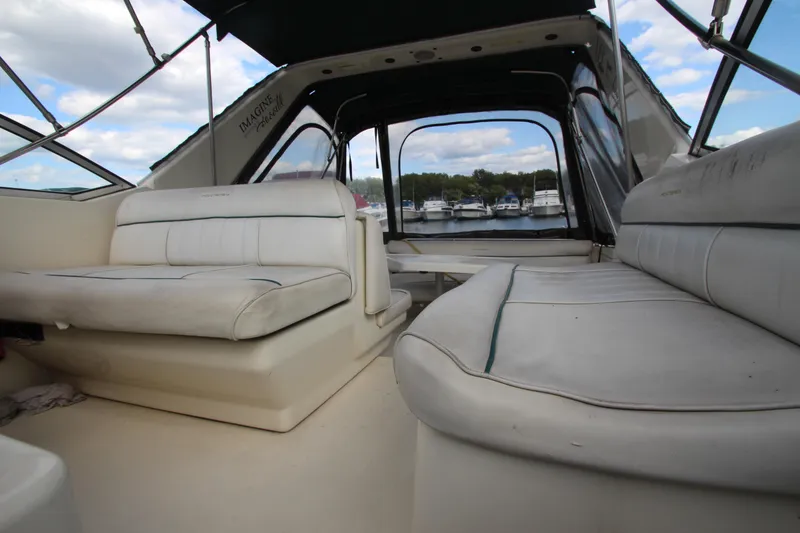 Slide: The Image of Interior view of 1996 Monterey 296 Cruiser boat with white seating and marina backdrop. - 20