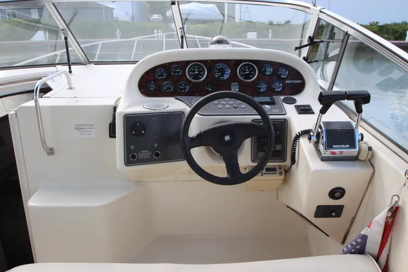 Slide: The Image of 1996 Monterey 296 Cruiser helm with steering wheel, gauges, and controls. - 5