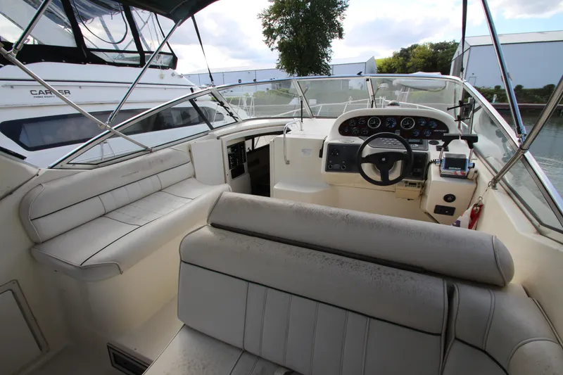 Slide: The Image of 1996 Monterey 296 Cruiser boat interior with steering wheel and seating area. - 6