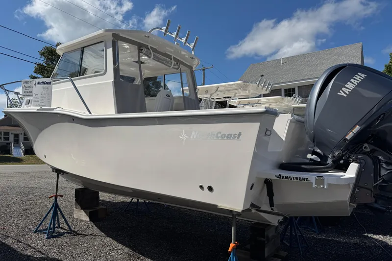 The Image of 2025 NorthCoast 255 HT boat with Yamaha engine on display under clear blue sky. - 0