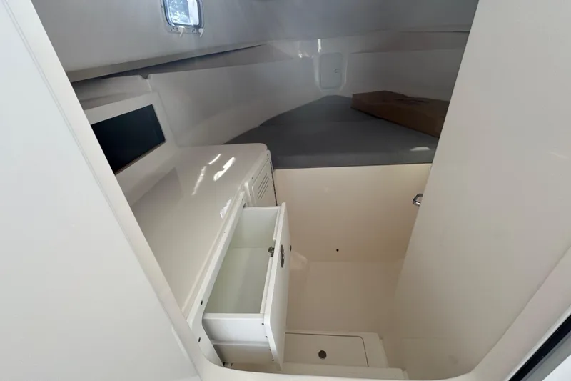 Slide: The Image of Interior cabin of 2025 NorthCoast 255 HT boat with storage and seating area. - 18