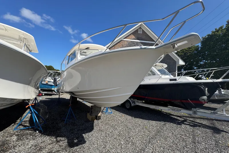 Slide: The Image of 2025 NorthCoast 255 HT boat displayed outdoors on stands under clear blue sky. - 2