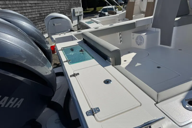 Slide: The Image of 2025 NorthCoast 255 HT boat deck with Yamaha engines, featuring seating and storage compartments. - 25
