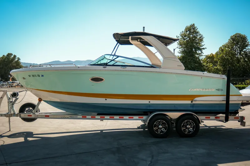 The Image of 2023 Chaparral 287 SSX boat on trailer, parked outdoors under clear sky. - 1