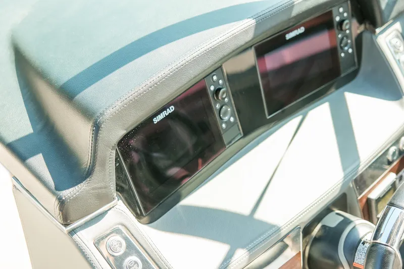 Slide: The Image of 2023 Chaparral 287 SSX dashboard featuring dual Simrad displays and steering wheel. - 10