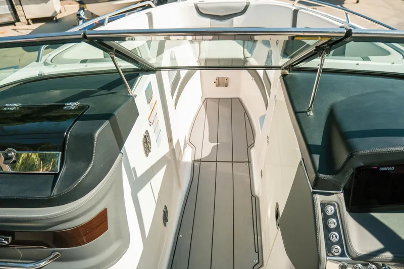 Slide: The Image of 2023 Chaparral 287 SSX boat interior with sleek design and modern controls. - 11