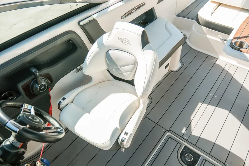 Slide: The Image of 2023 Chaparral 287 SSX boat interior with white seating and modern steering wheel. - 14