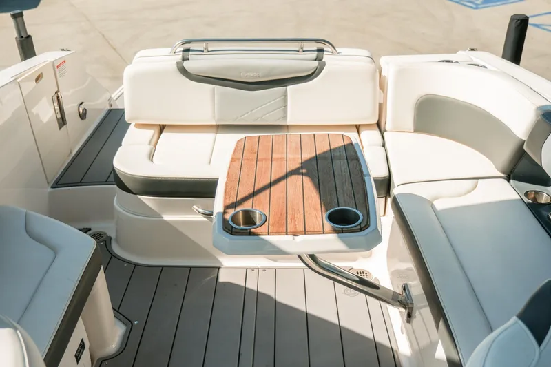 Slide: The Image of 2023 Chaparral 287 SSX boat interior with elegant seating and wooden table. - 15