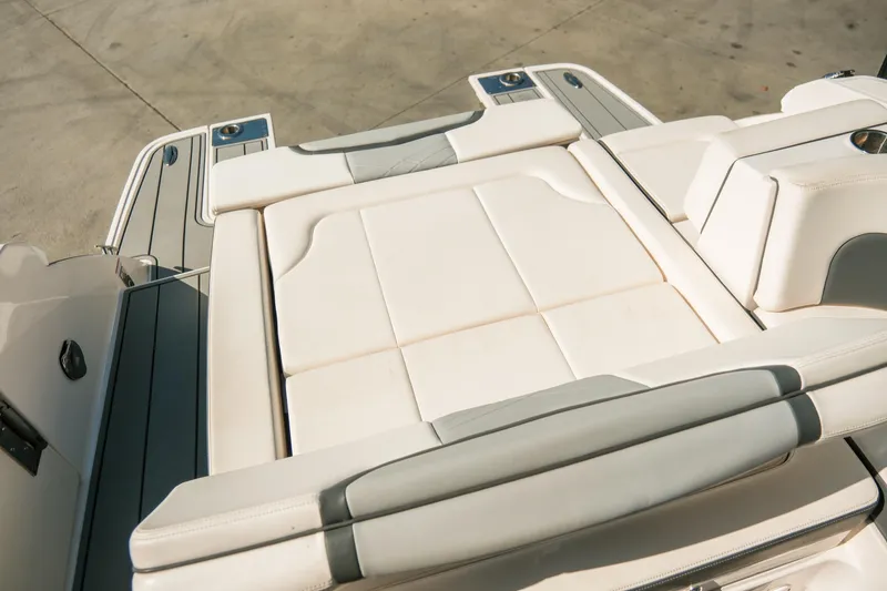 Slide: The Image of 2023 Chaparral 287 SSX boat with luxurious white seating and sleek design. - 18