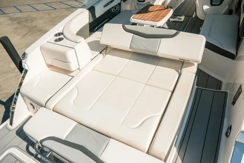 Slide: The Image of 2023 Chaparral 287 SSX boat interior with luxurious seating and table. - 19