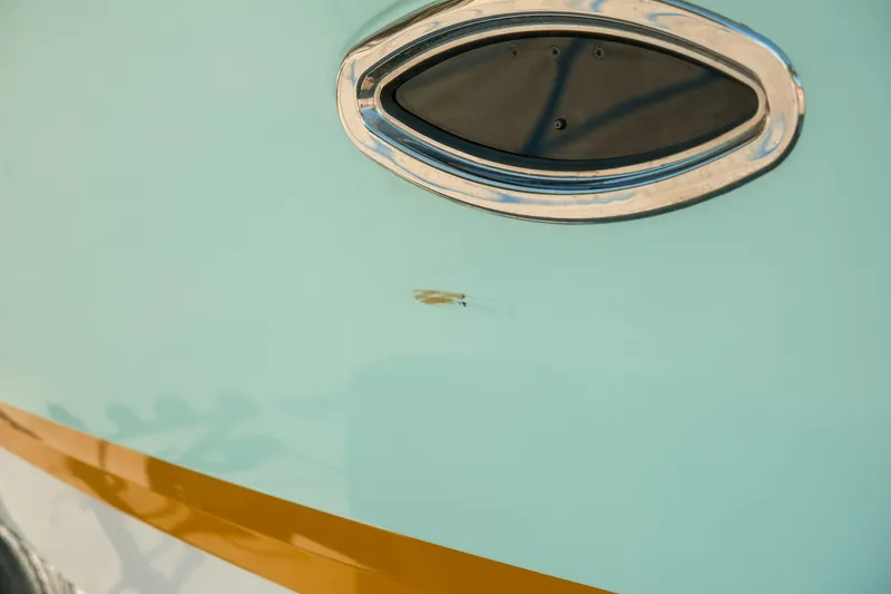 Slide: The Image of 2023 Chaparral 287 SSX boat detail with oval window and sleek design. - 28