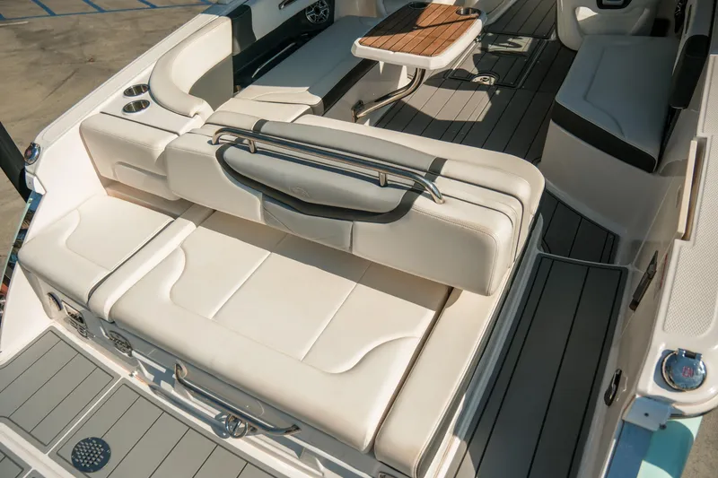 Slide: The Image of 2023 Chaparral 287 SSX boat interior with luxurious seating and wooden table. - 6