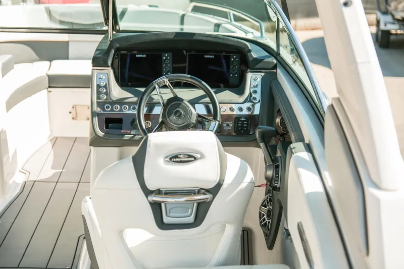 Slide: The Image of 2023 Chaparral 287 SSX boat cockpit with modern steering and control panel. - 8