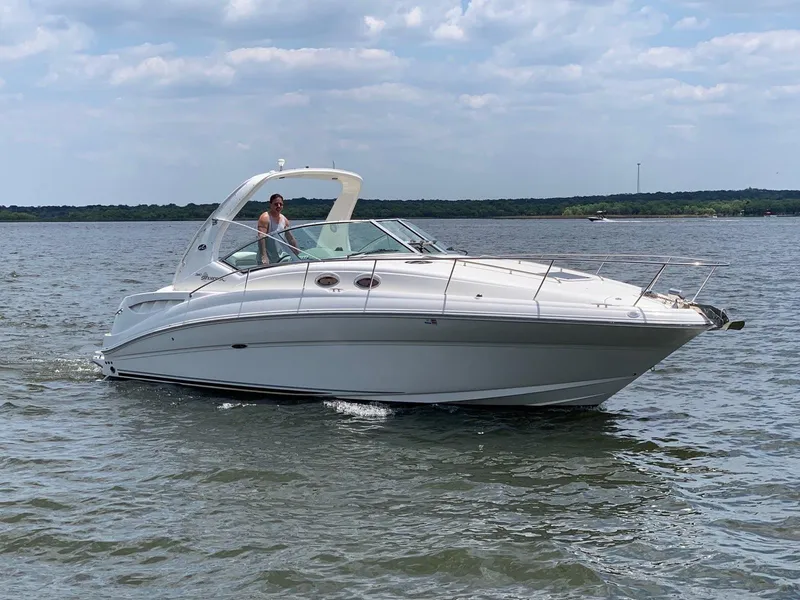 The Image of 2007 Sea Ray 320 Sundancer cruising on a calm lake under a partly cloudy sky. - 0