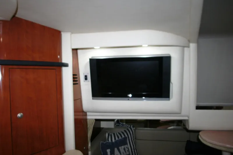 Slide: The Image of Interior of 2007 Sea Ray 320 Sundancer with TV and wooden cabinetry. - 10