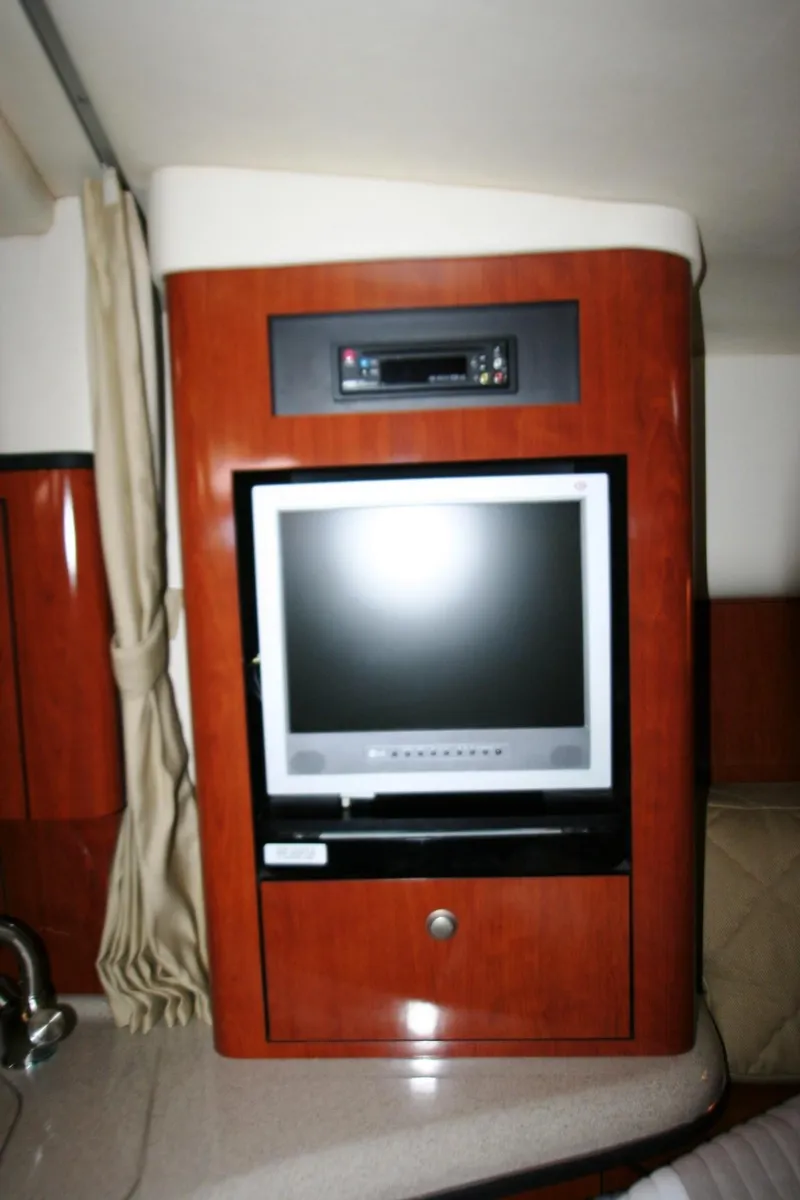 Slide: The Image of 2007 Sea Ray 320 Sundancer interior with built-in TV and entertainment system. - 12