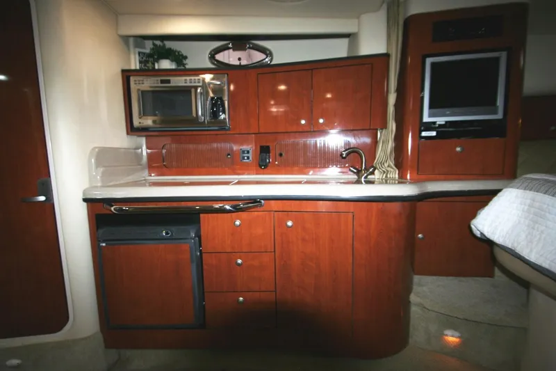 Slide: The Image of 2007 Sea Ray 320 Sundancer interior with kitchenette, microwave, and TV. - 13
