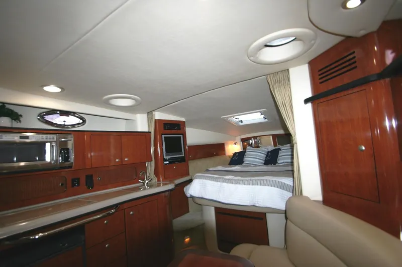 Slide: The Image of Interior of 2007 Sea Ray 320 Sundancer with seating, TV, and spiral stairs. - 16