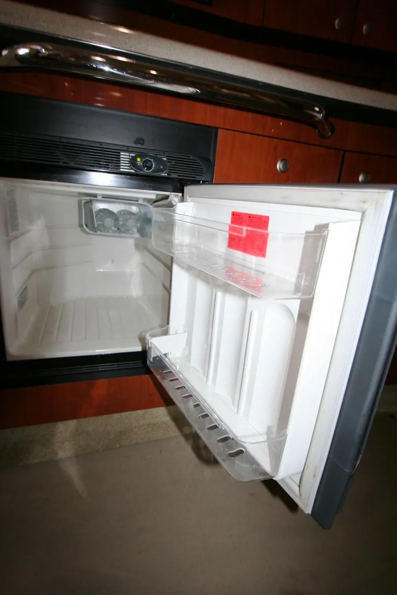 Slide: The Image of 2007 Sea Ray 320 Sundancer stovetop with two burners in a compact kitchen area. - 20