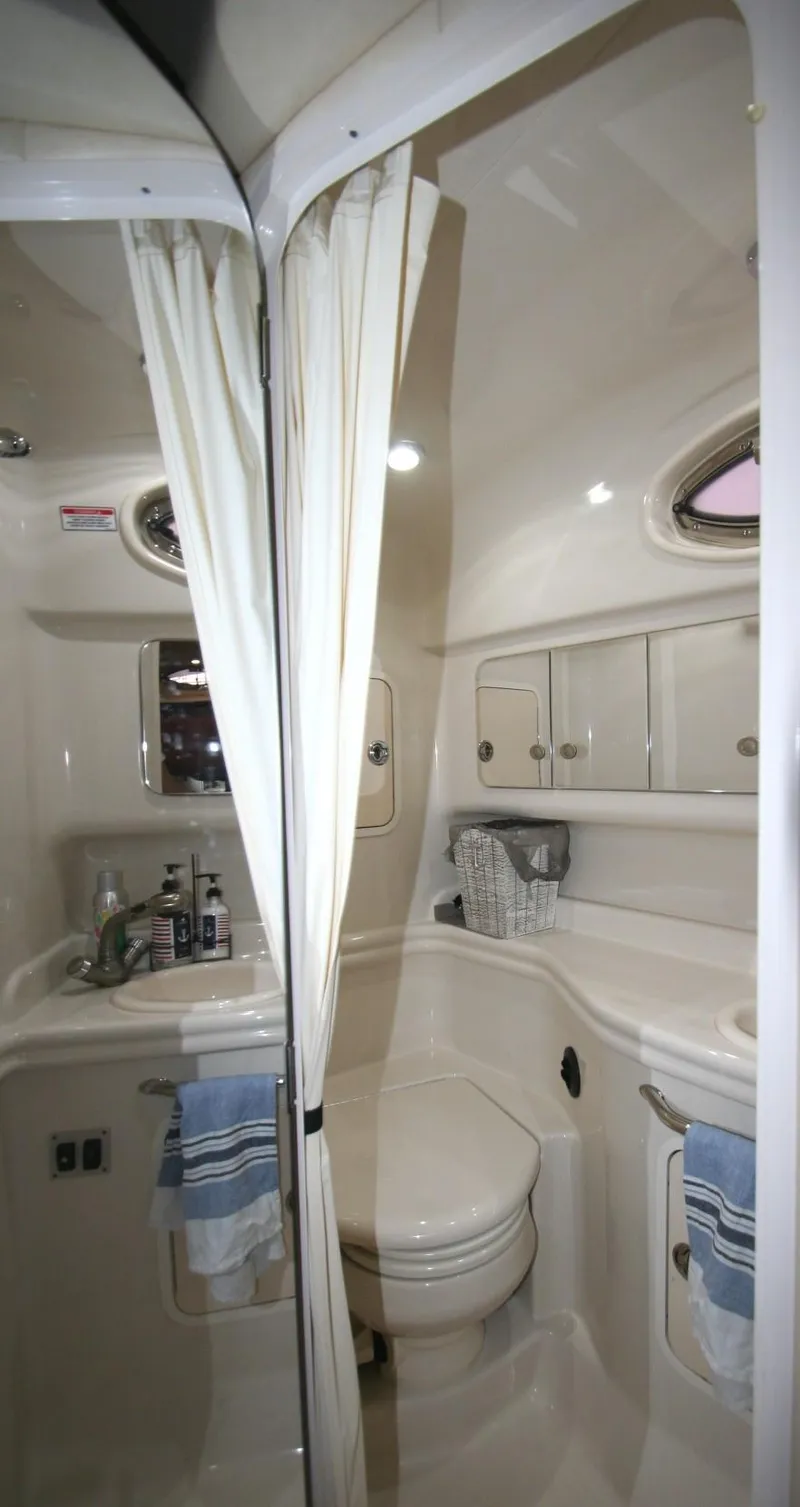 Slide: The Image of Helm of 2007 Sea Ray 320 Sundancer with navigation controls and wood-accented steering wheel. - 23