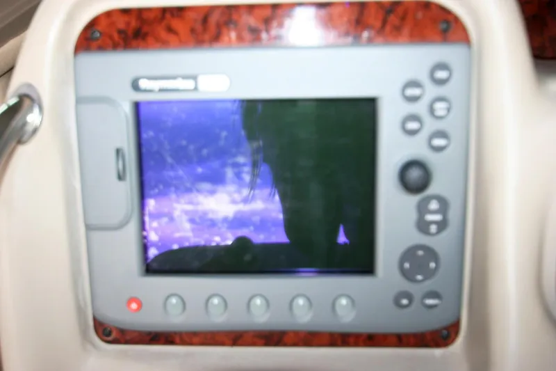 Slide: The Image of Helm of 2007 Sea Ray 320 Sundancer with wood accents and navigation controls. - 26