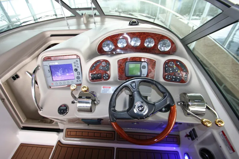 Slide: The Image of 2007 Sea Ray 320 Sundancer interior with kitchenette, bed, and wooden cabinetry. - 27