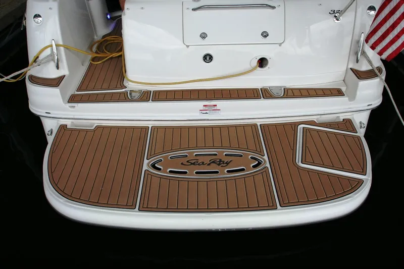 Slide: The Image of 2007 Sea Ray 320 Sundancer swim platform with teak-style decking and logo. - 3
