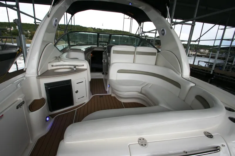 Slide: The Image of 2007 Sea Ray 320 Sundancer interior with open mini fridge on teak deck. - 36