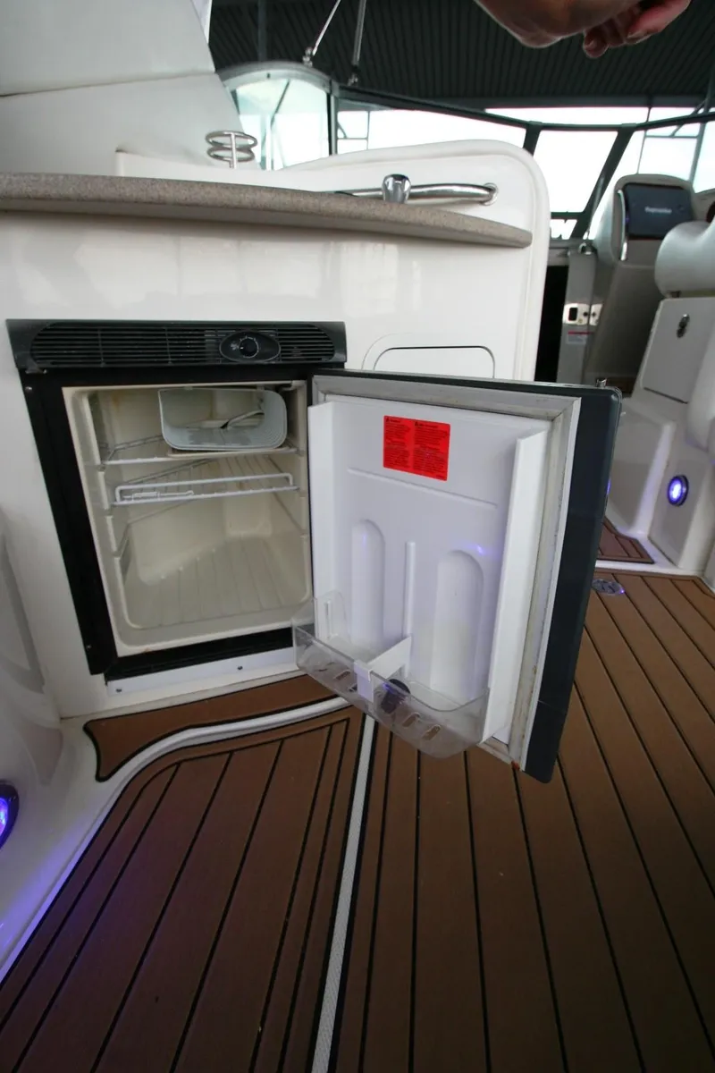 Slide: The Image of 2007 Sea Ray 320 Sundancer interior with seating, sink, and wood flooring. - 38
