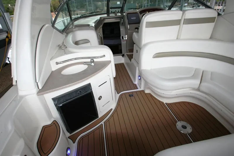 Slide: The Image of 2007 Sea Ray 320 Sundancer boat interior with white seating and wooden deck. - 40