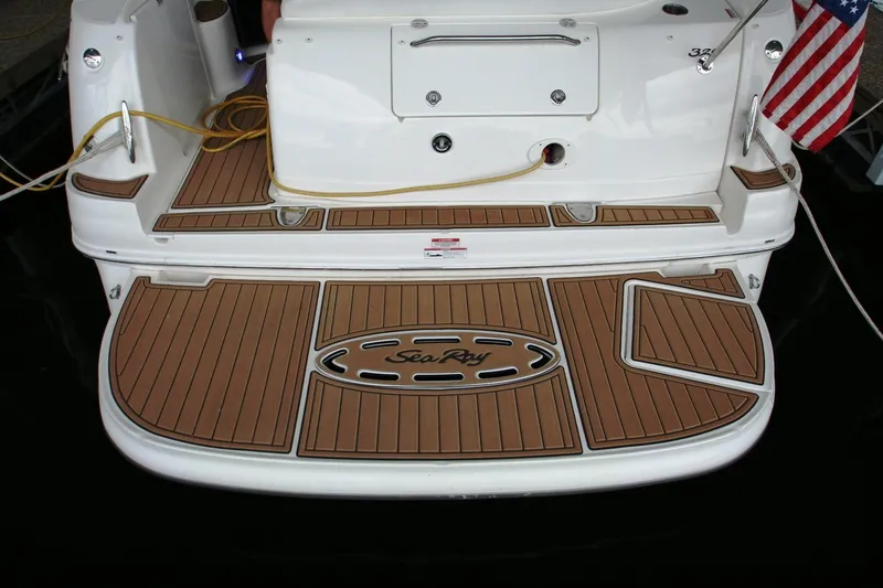Slide: The Image of 2007 Sea Ray 320 Sundancer yacht stern view with teak decking and mooring lines. - 42