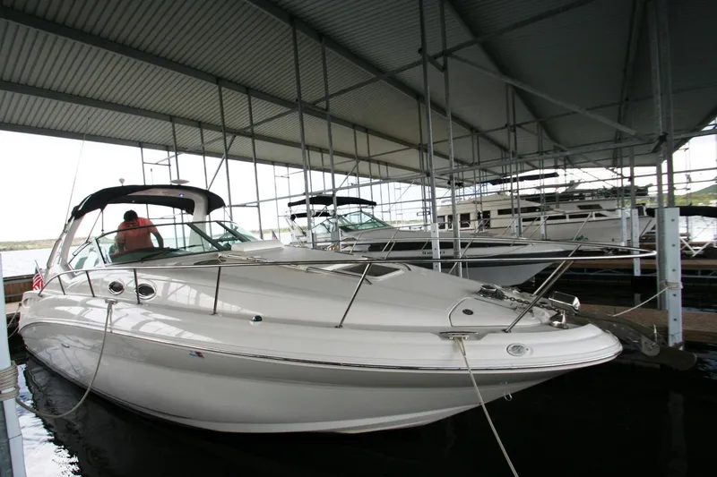 Slide: The Image of 2007 Sea Ray 320 Sundancer boat docked in marina, showcasing sleek deck design. - 46