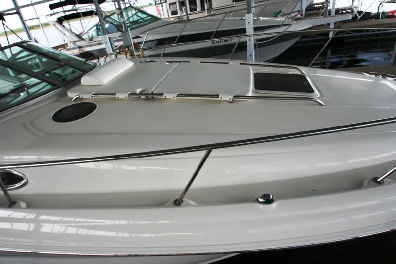 Slide: The Image of 2007 Sea Ray 320 Sundancer docked under a covered marina. - 47