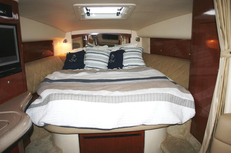 Slide: The Image of Luxurious cabin interior of 2007 Sea Ray 320 Sundancer with cozy bedding and elegant wood finishes. - 6