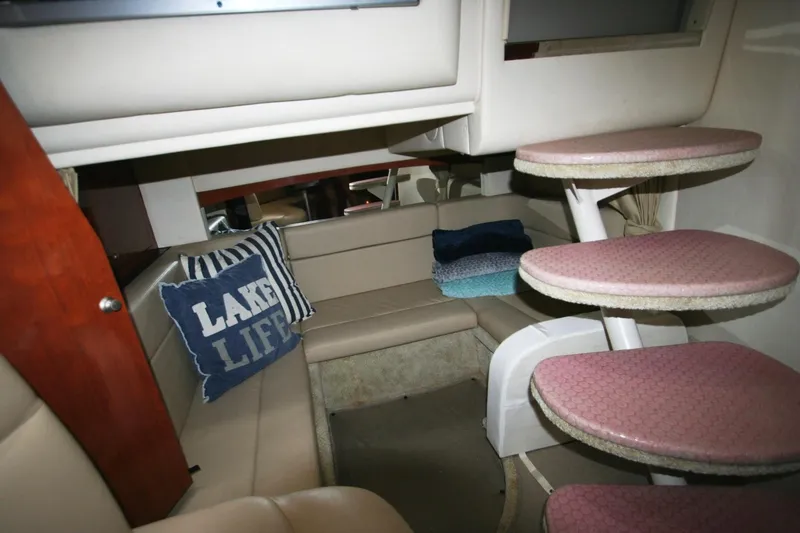 Slide: The Image of Interior of 2007 Sea Ray 320 Sundancer with cozy seating and decorative pillows. - 9